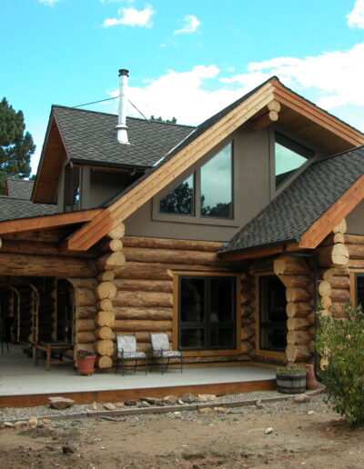A log home with a black roof